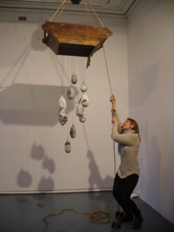 martha cashman hanging a cloud from the ceiling wooden frame with ceramic raindrops